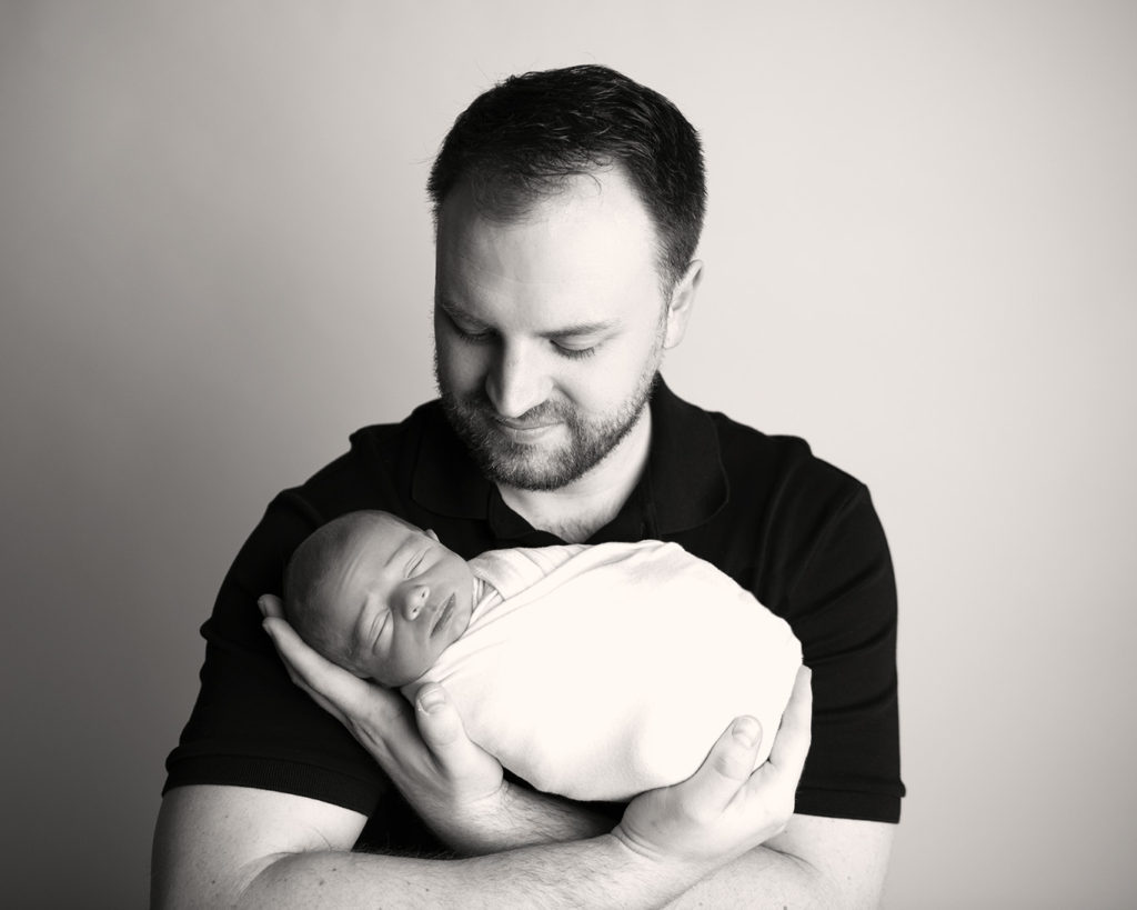 newborn with dad black and white daddy with son