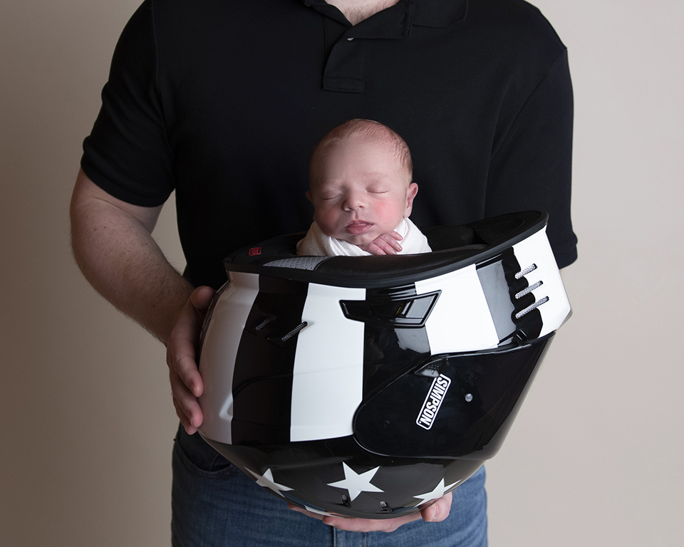 newborn with motorcycle helmet dad