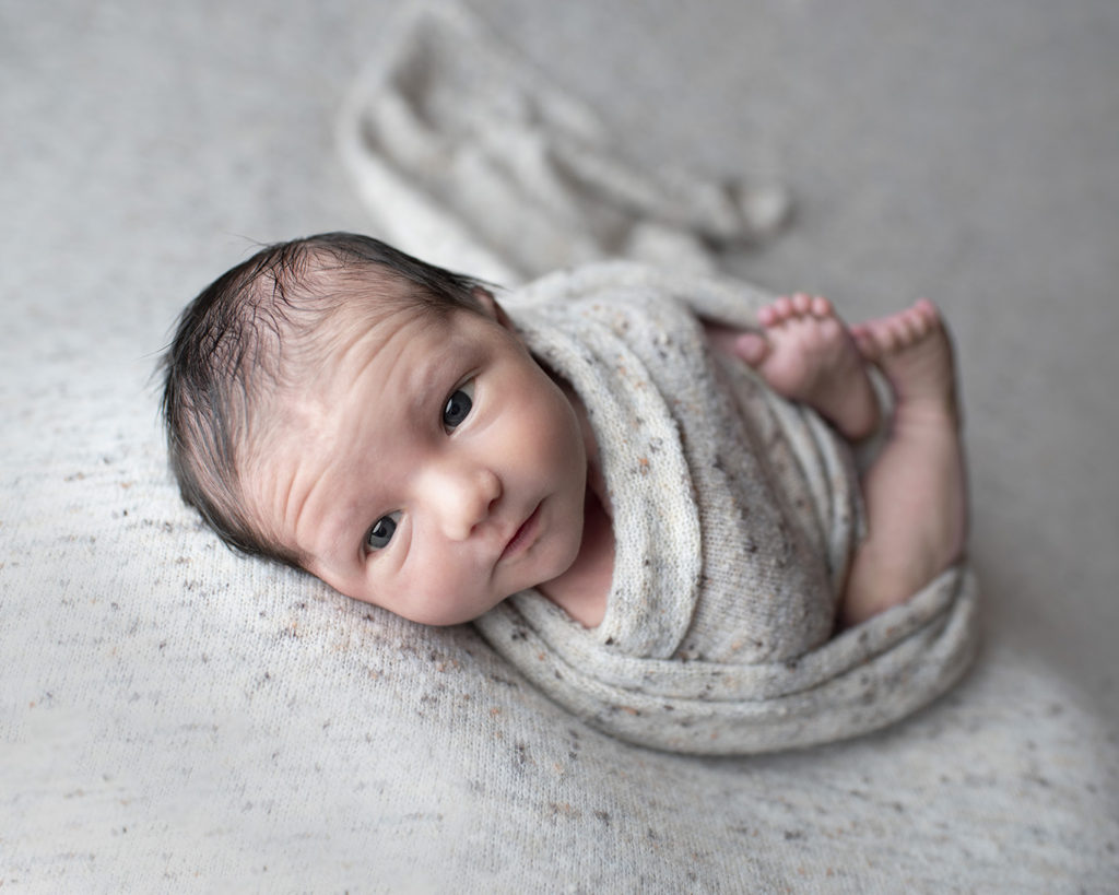 neutral baby boy newborn pose