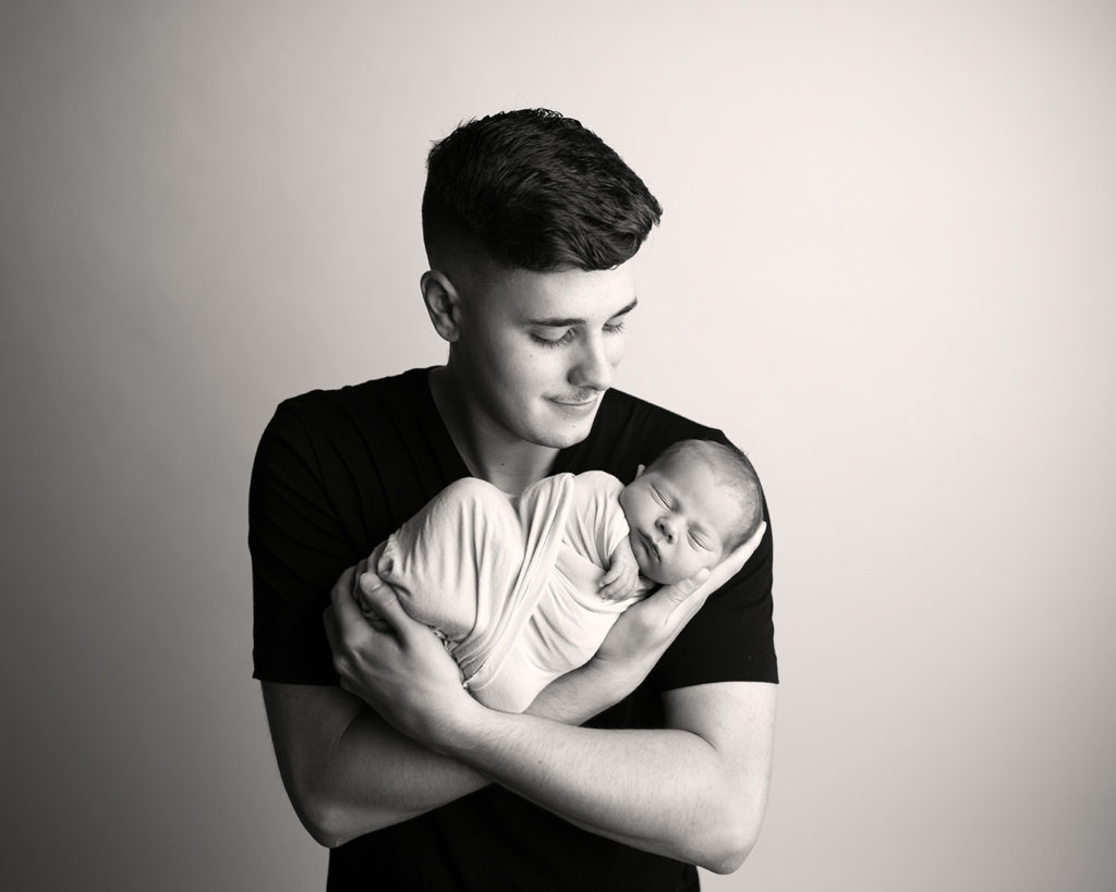 baby boy newborn with dad kcbphotographyllc